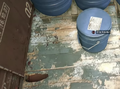 Zinc powder within a red train car filler with blue chemical barrels