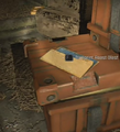 The blueprint's placement atop a pile of orange chests