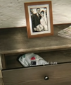 The outfit's placement within the drawer, the picture standing above it.